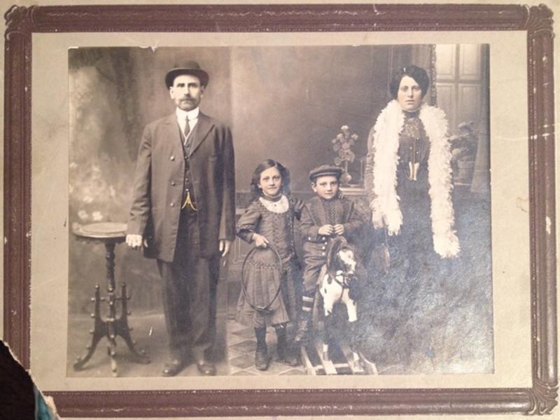 Polish Jewish mother, father, young son and daughter posing in their best clothes for formal family photo circa 1915.